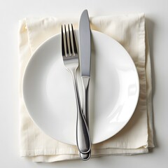 Silverware on white plate with cream napkin - elegant table setting