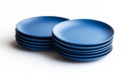 35.A set of round blue plates in matte finish, stacked and spread out in a balanced layout, captured on a bright white background with crisp lighting.