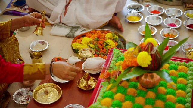 Worshiper rings bell and holds incense at altar