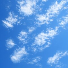 Fototapeta premium Fluffy clouds drift across blue sky