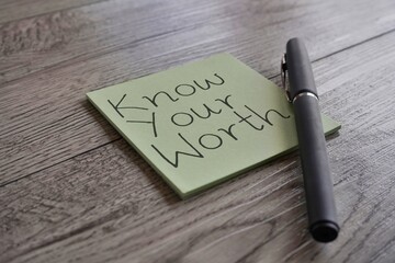 A light green sticky note with the handwritten phrase 