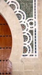 Geometric, green tile frame around a wooden door in the medina, in Fez, Morocco