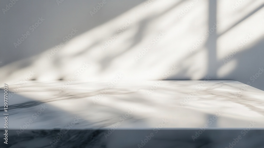 Poster marble tabletop with gentle gray streaks, reflecting soft ambient light, forming abstract shadow pat