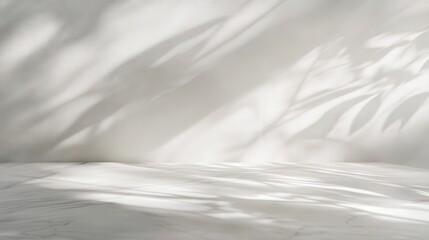 Fototapeta premium pristine white marble tabletop with light gray streaks, receiving soft directional light, forming artistic abstract shadows on the white wall.
