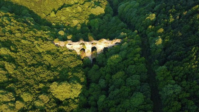 Kurşungerme Kemeri, hidden among the dense forest cover, drone image. This historical structure, integrated with nature, reveals the importance of waterways in the past.