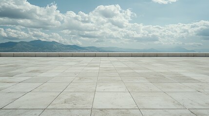Empty Plaza Overlooking City and Mountains Under a Blue Sky