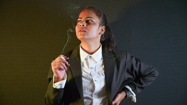 Businesswoman wear formal attire smokes pensively