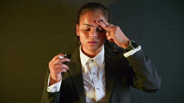 Thoughtful woman exhales cigarette in silence