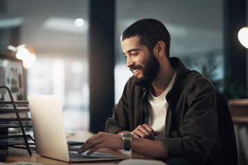 Design, laptop and programming with happy man in office at night for coding or computer...