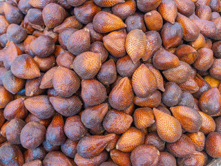 Close up view of a bunch of piled up Snake Fruit at a village street market in Chinatown of Baduy, Indonesia