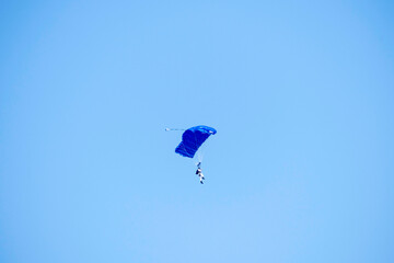 Paragliding on isolated blue sky in mid-air
