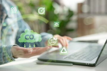 A man exploring CO2 reduction techniques and sustainability initiatives using digital interface, aimed at environmental conservation