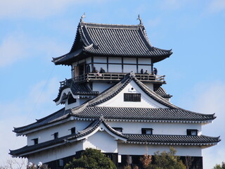 Inuyama Castle in Aichi Prefecture, Japan: A national treasure castle shining against the blue sky. February 11, 2025