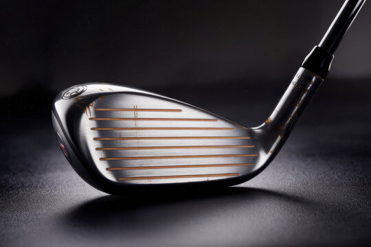 a golf club isolated on a dark background, perfect for sports posters