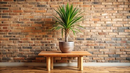 A vibrant green potted plant rests on a rustic wooden coffee table, set against a textured brick wall, creating a minimalist yet inviting interior design scene.