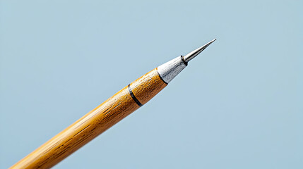 Naklejka premium Close Up Of Yellow Wooden Pencil With White Tip On Light Blue Background