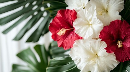 Fototapeta premium Tropical blossoms vivid hibiscus contrasting petals on monstera leaves creating a vibrant summer floral display ideal for exotic themes
