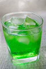a drink in a glass on a white background, melon soda