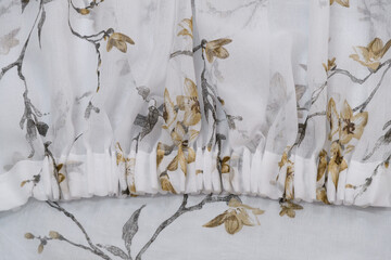 Edging of delicate cloth. Sewing production in the details of the fabric.