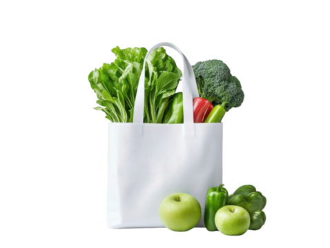 Reusable white grocery bag filled with fresh vegetables and ripe apples for healthy eating sustainable shopping