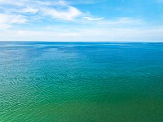 Aerial view of beautiful sea in summer season sky background,Drone view Waves water surface texture on sunny tropical ocean in Phuket island Thailand