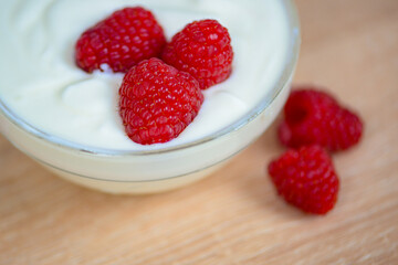 Fresh raspberry close-up in yogurt, macro,healthy breakfast