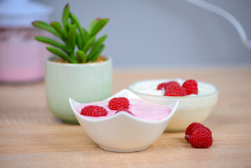 Raspberry dessert on the table in the kitchen, healthy breakfast