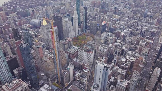 Construction crane on a skyscraper in Midtown Manhattan, near iconic buildings including MetLife Building is skyscraper at Park Avenue and 45th Street