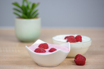 Raspberry dessert on the table in the kitchen, healthy breakfast