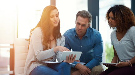 Creative people, meeting and discussion with tablet for brainstorming or project planning at...