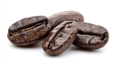 Close-up of four roasted coffee beans isolated on white.