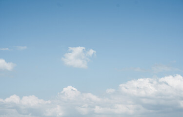 A stunning image showcasing a clear blue sky with soft, scattered white clouds