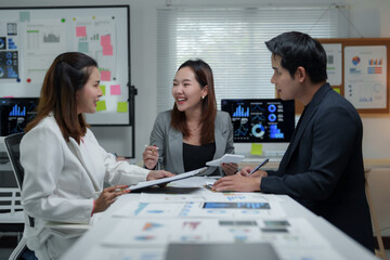 Asian businesspeople discussing and working together in office meeting