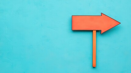 Vibrant Orange Arrow Sign Against Bright Turquoise Background for Directional Guidance and Signage Use