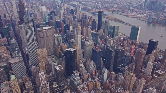 High rise buildings including 200 Park Avenue and Chrysler Building crowd Midtown Manhattan, New York City, with visible East River