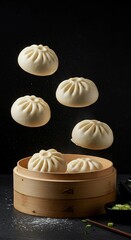 Steamed buns levitating above a bamboo steamer, with two buns inside, against a dark background.
