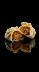 Two steamed dumplings, one cut open, revealing savory filling, on black background.