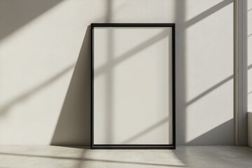 A blank picture frame against a white wall with shadows present