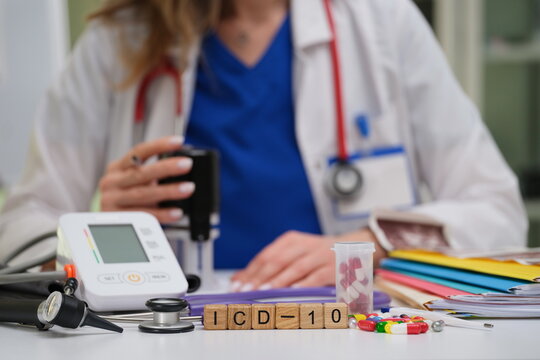 A qualified medical professional is analyzing crucial data with necessary tools and ICD10 code references