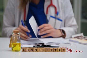 A qualified doctor meticulously studies various medical paperwork with a specific focus on...