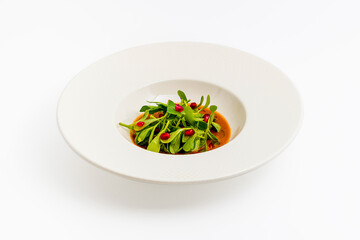 Purslane salad with olive oil and pomegranate in a white porcelain plate