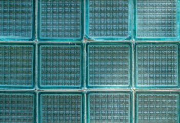 Glass block wall forming geometric pattern with translucent architectural blocks used in modern building design