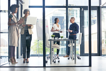Boardroom, glass office and meeting with group business people at work together for discussion or planning. Collaboration, project management or workshop with employee men and women in conversation
