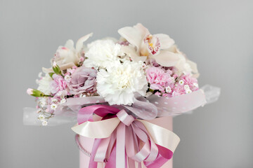 The bouquet is isolated on a gray background with space for text. Background with flowers. A gift for a beloved woman. International Women's Day. Concept of love