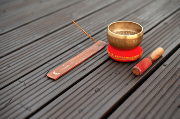 Tibetan Singing Bowl and Incense on Wooden Surface