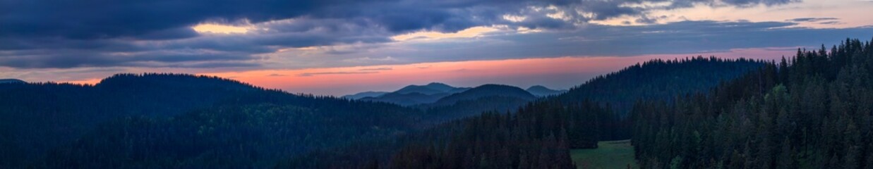 Panoramic view of a mountain range at sunrise, sunset. A breathtaking panoramic view of a mountain range at sunrise or sunset. Pamparova Bulgaria 