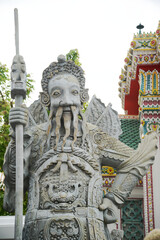 Chinese guardian statue at the gate of Wat Pho Which is one of the largest and oldest temples in Bangkok and is popular with both Thai and foreign tourists.