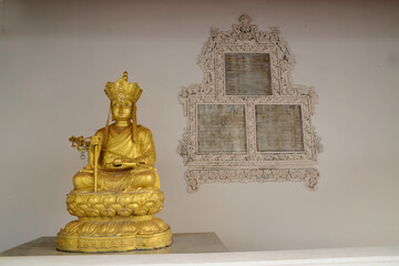 A golden Chinese-style Buddha statue is decorated in the Sala Rai at Wat Pho, one of the largest...