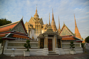 Fototapeta premium Scenic evening time of Classic Thai architecture with pagoda in Wat Phra Chetuphon or Wat Pho. Which is one of the largest and oldest temples and is popular with both Thai and foreign tourists.