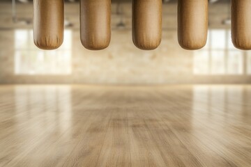 Wooden bowling pins poised above polished floor, bathed in soft